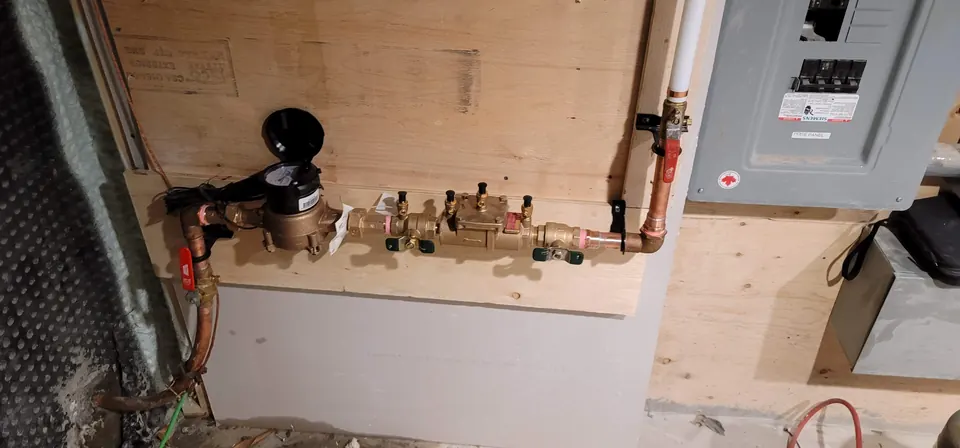 Water meter followed by backflow prevention assemblies on a water service