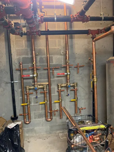 Copper water manifold with valves in a commercial mechanical room