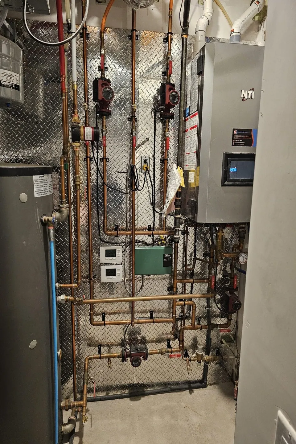 Mechanical room with boiler controls and copper distribution piping